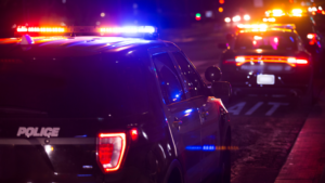 Police cars with flashing lights at night