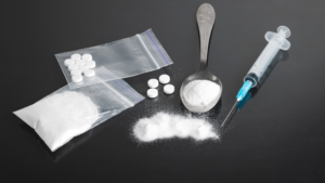 Drug paraphernalia: powder, pills, syringe, spoon