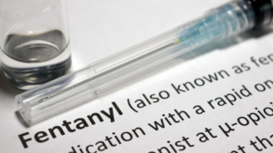 Fentanyl vial and syringe on document