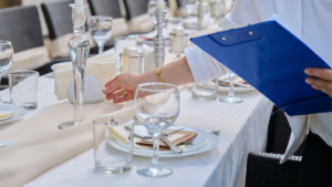 Server setting elegant table with blue clipboard